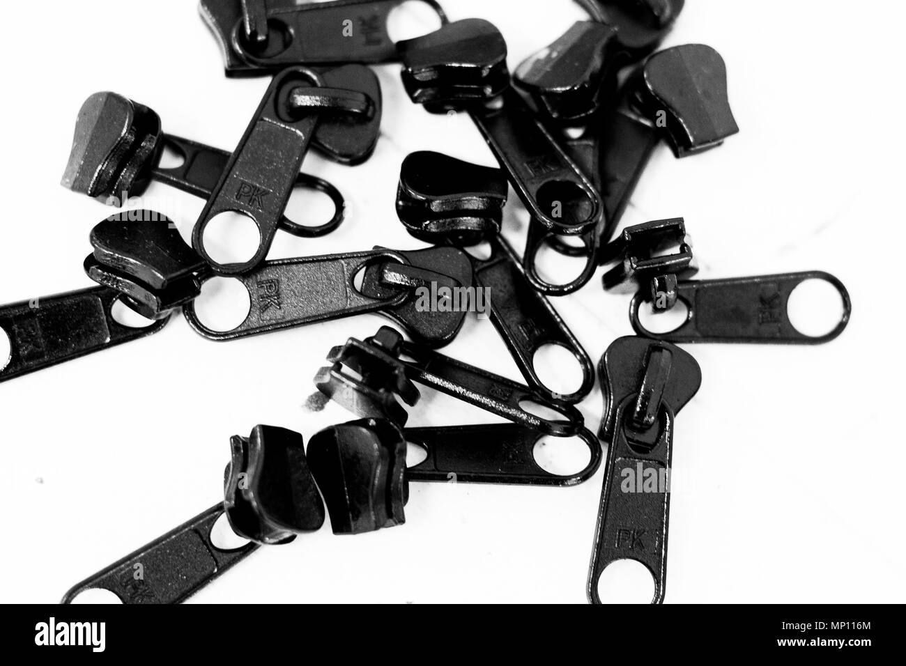 Zipper fasteners from above in black and white Stock Photo