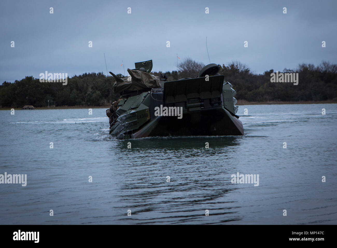 U.S. Marines with 2nd Assault Amphibian Battalion (2d AABN), 2nd Marine Division (2d MARDIV), conduct an amphibious movement aboard an AAV-7A1 Assault Amphibious Vehicle during the unit's Marine Corps Combat Readiness Evaluation (MCCRE) on Camp Lejeune, N.C., March 12, 2018. The MCCRE is a pre-deployment training evaluation designed to test the skills of Marines and Sailors with possible combat scenarios. Stock Photo