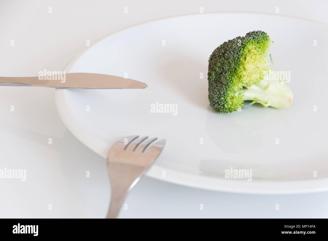 Empty dish with single cabbage vegetable meaning diet concept Stock