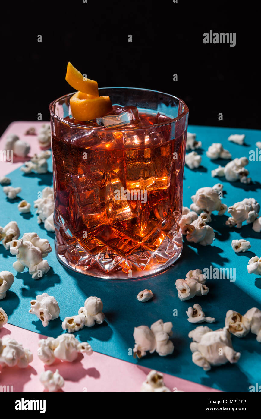 Negroni IBA cocktail, with gin, bitter, vermut, in pop contemporary style, colorful, dark