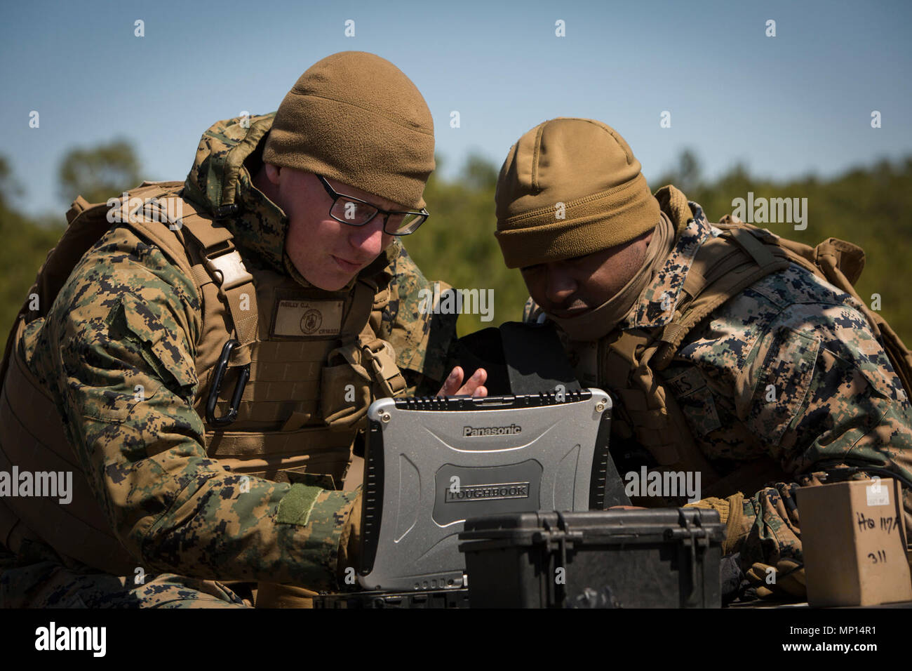 U.S. Marine Corps Cpl. Connor Reilly, an intelligence specialist, and Sgt. Dominique Dillard, a senior analyst with 3rd Battalion, 2nd Marine Regiment, 2nd Marine Division (2d MARDIV), perform a functions check during Marine Corps Combat Readiness Evaluation (MCCRE) on Camp Lejeune, N.C., March 13, 2018. The MCCRE is a pre-deployment training evaluation designed to test the skills of Marines and Sailors with possible combat scenarios. Stock Photo