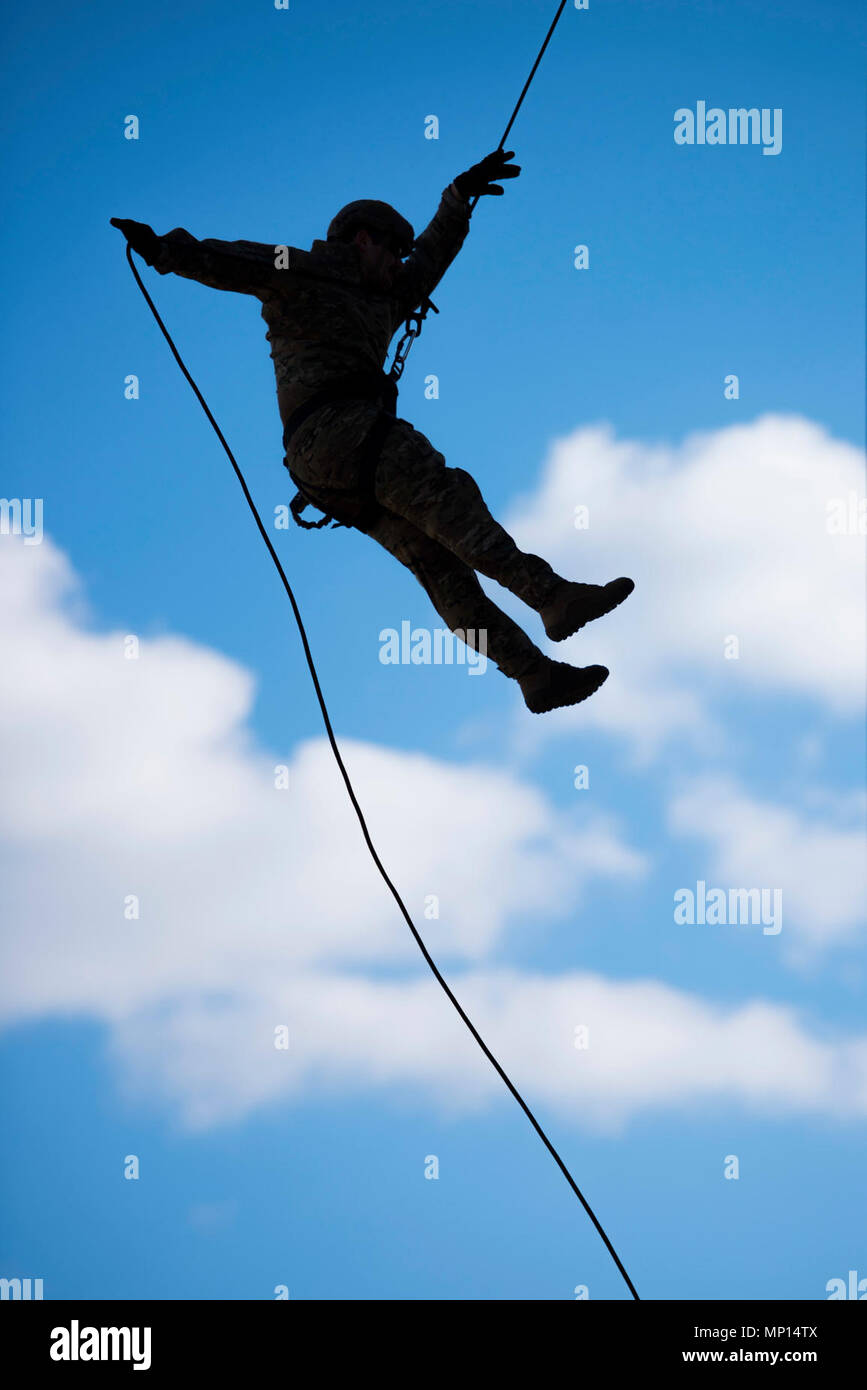 VIRGINIA BEACH, Va. (March 13, 2018) An explosive ordnance disposal technician, assigned to Explosive Ordnance Disposal Group (EODGRU) 2, rappels during helicopter rope suspension technique (HRST) training at Joint Expeditionary Base Fort Story. EODGRU 2 is headquartered at Joint Expeditionary Base Little Creek-Fort Story and oversees Mobile Diving and Salvage Unit Two (MDSU 2) and all east coast based Navy EOD mobile units. Stock Photo