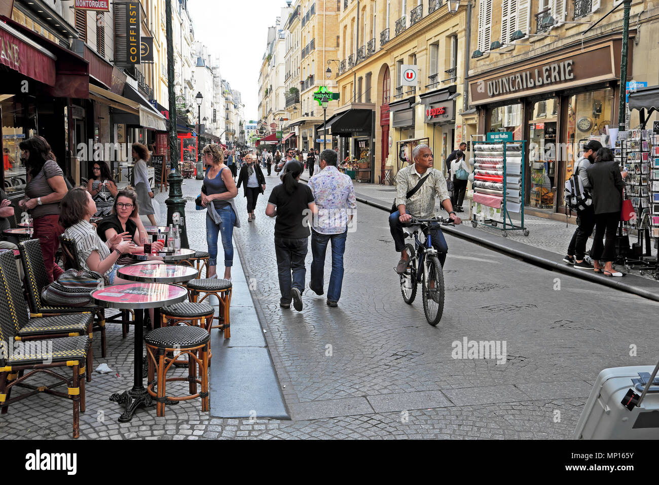 People strolling and man cycling along Rue Montorgueil street near Les Halles neighborhood  in Central Paris France Europe EU  KATHY DEWITT Stock Photo