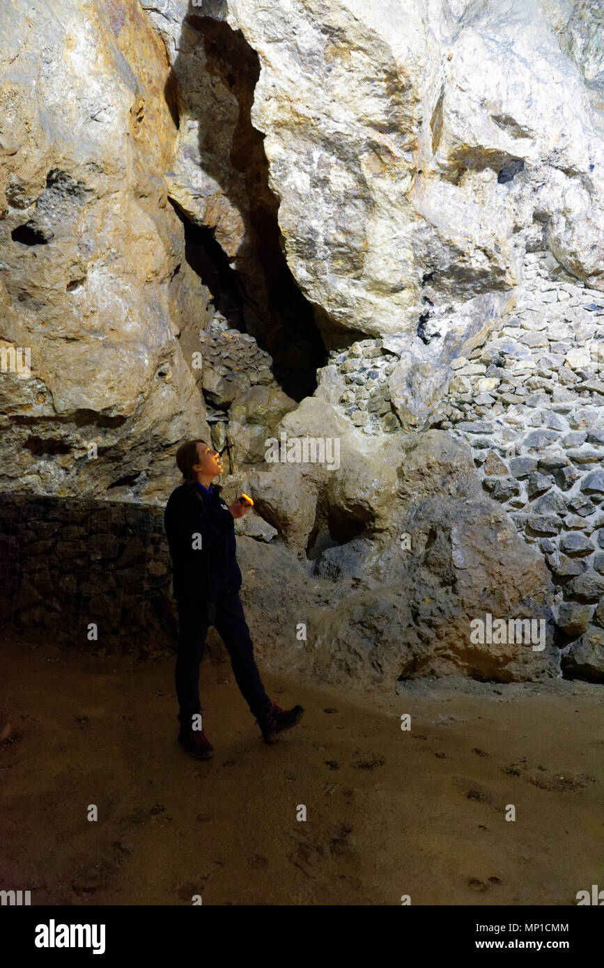 A guide with a torch in the Great Masson Cavern, Heights of Abraham, Matlock, Derbyshire Stock Photo