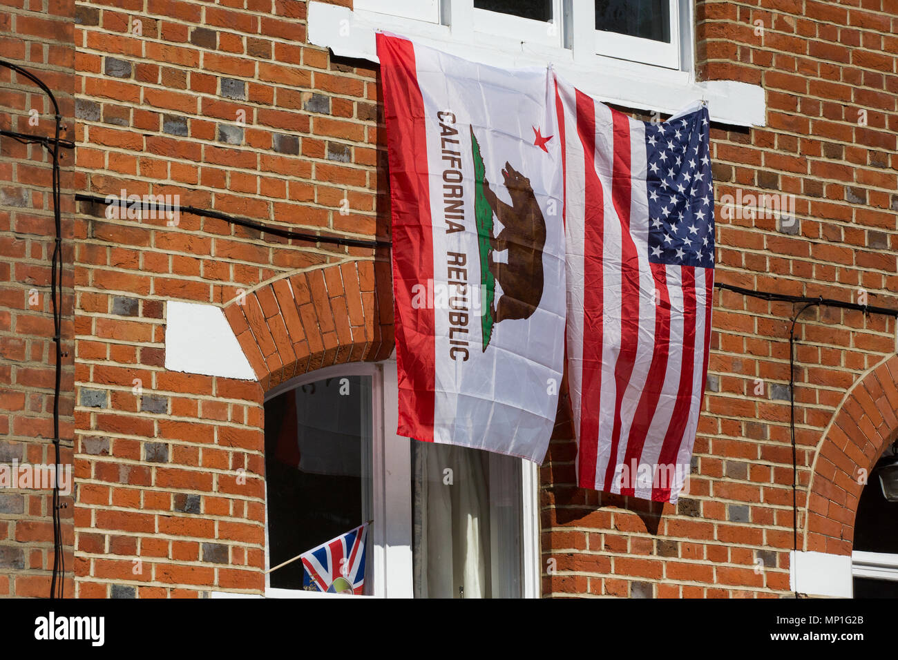 Windsor, UK. 20th May, 2018. California Republic and American flags hang from a property on Kings Road for the procession to follow the royal wedding  Stock Photo