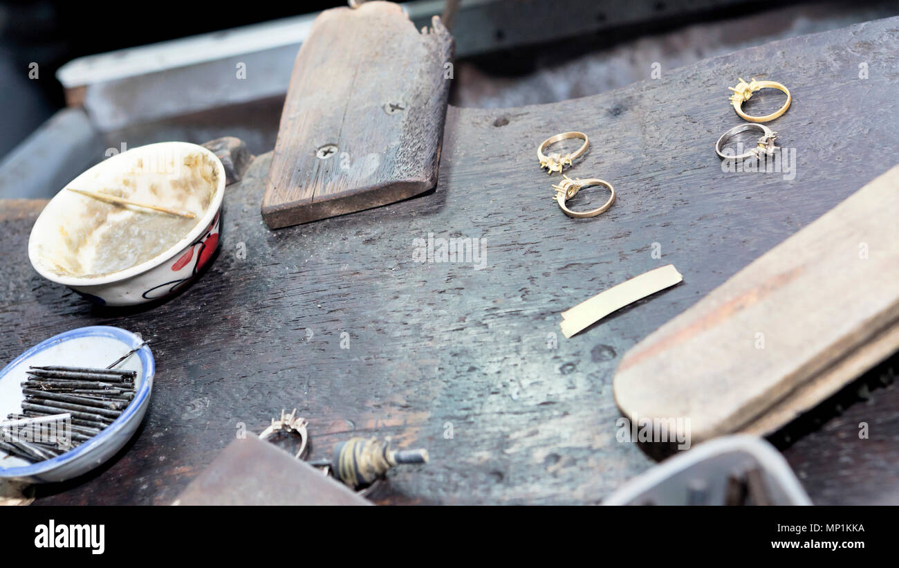Goldsmith's bench with some golden rings in process selectived focus Stock Photo Alamy