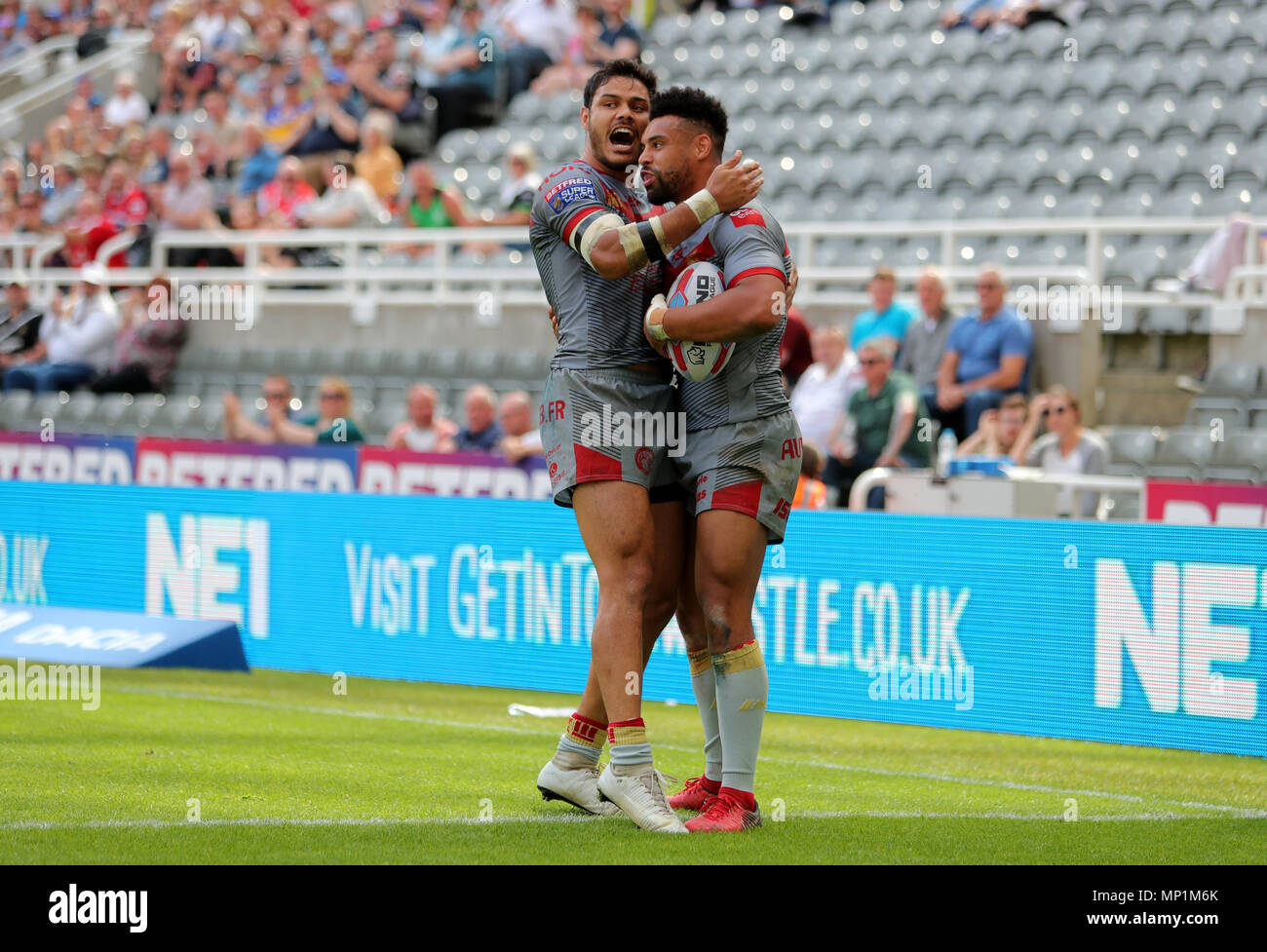 Catalan Dragons Brayden Wiliame with Jodie Broughton after he scores a try during the Betfred Super League, Magic Weekend match at St James' Park, Newcastle. Stock Photo