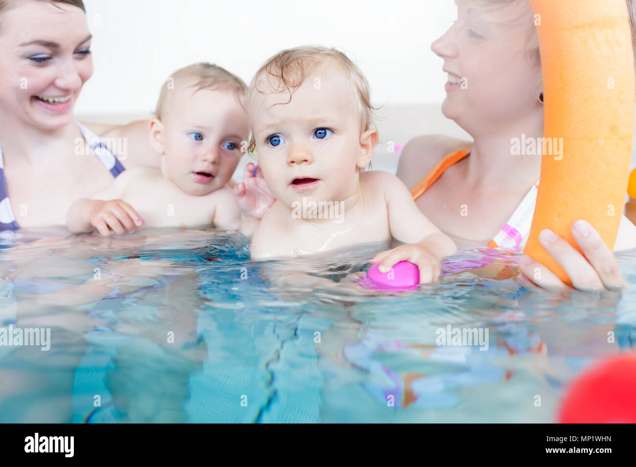 Mothers being happy about their babies playing with each other Stock Photo