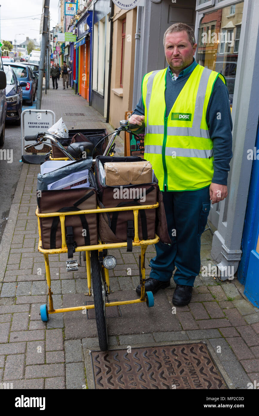 Irish Post Office, An Post, Postman with letter and parcel carrying bicycle, Cahersiveen, County Kerry, Ireland Stock Photo