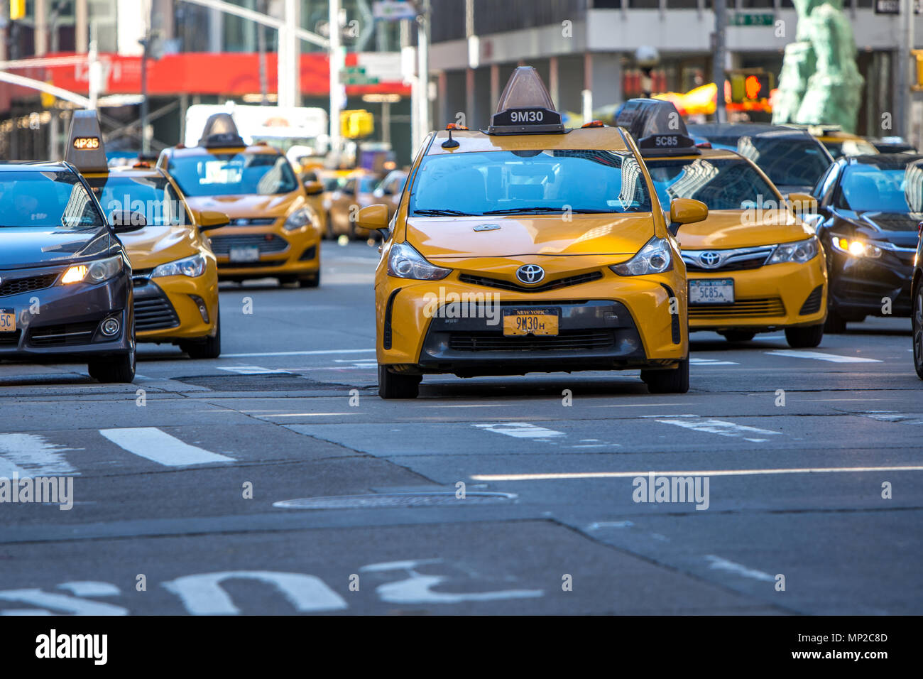 New York, US - March 31, 2018: The famous yellow taxis as seen in road traffic in New York city on a sunny day Stock Photo