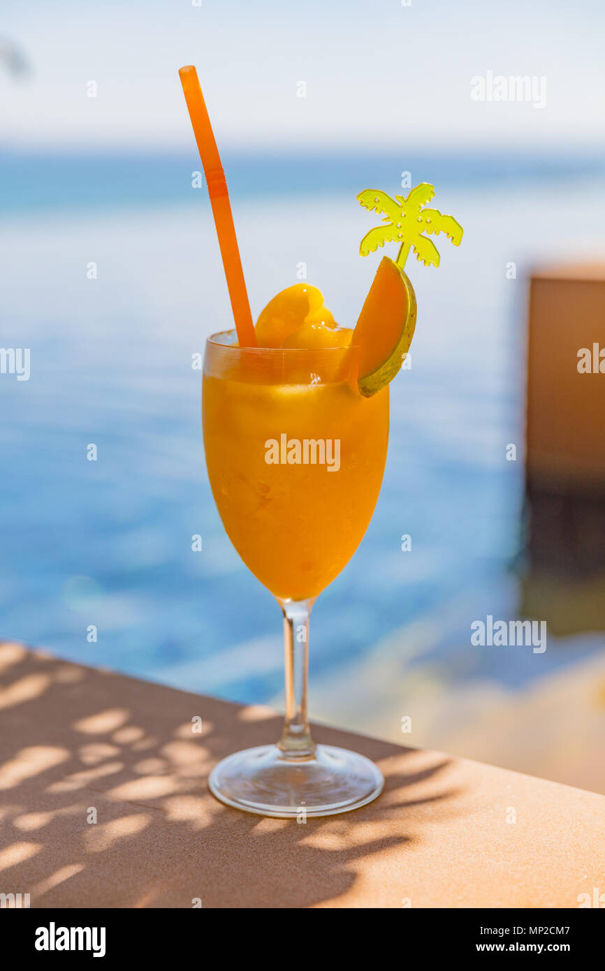 Mango Juice In Glass At Poolside Stock Photo - Alamy