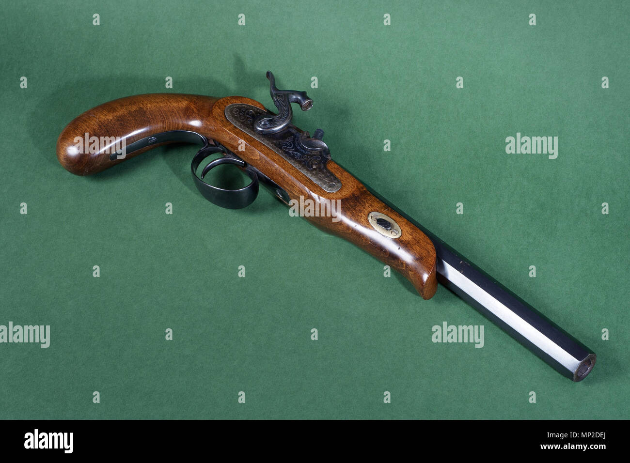 Old duel pistol on green background Stock Photo - Alamy