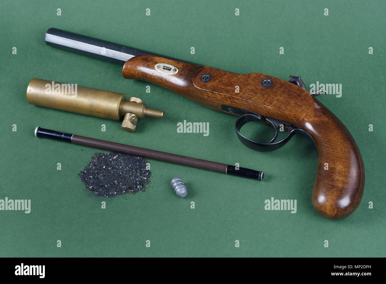 Old duel pistol with an accessory on green background Stock Photo - Alamy