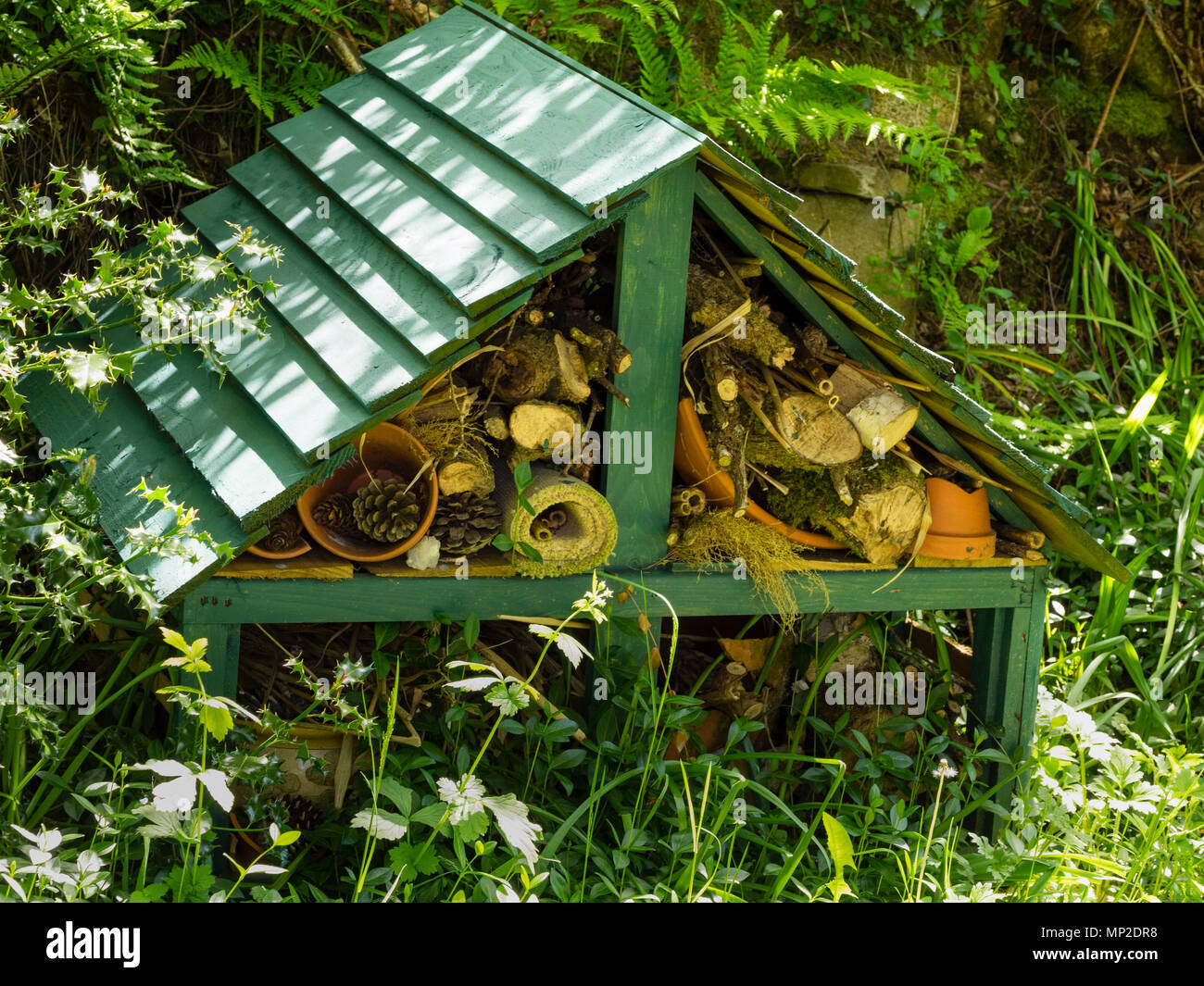 Bug hotel for sheltering and attracting insects and other wildlife to the garden Stock Photo