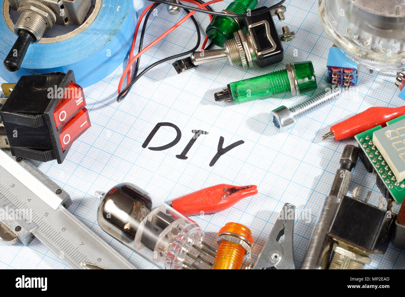"Do it yourself" radioelectronic parts on graph paper background