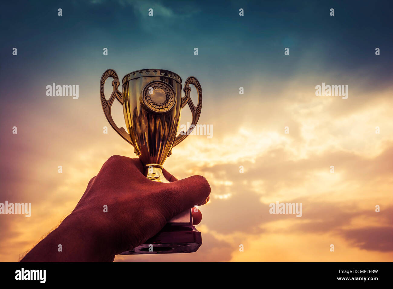 Hand holding winner trophy Stock Photo