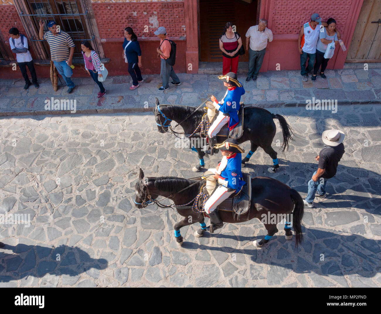 Two uniformed riders on horseback in a parade in San Miguel de Allende, Mexico Stock Photo