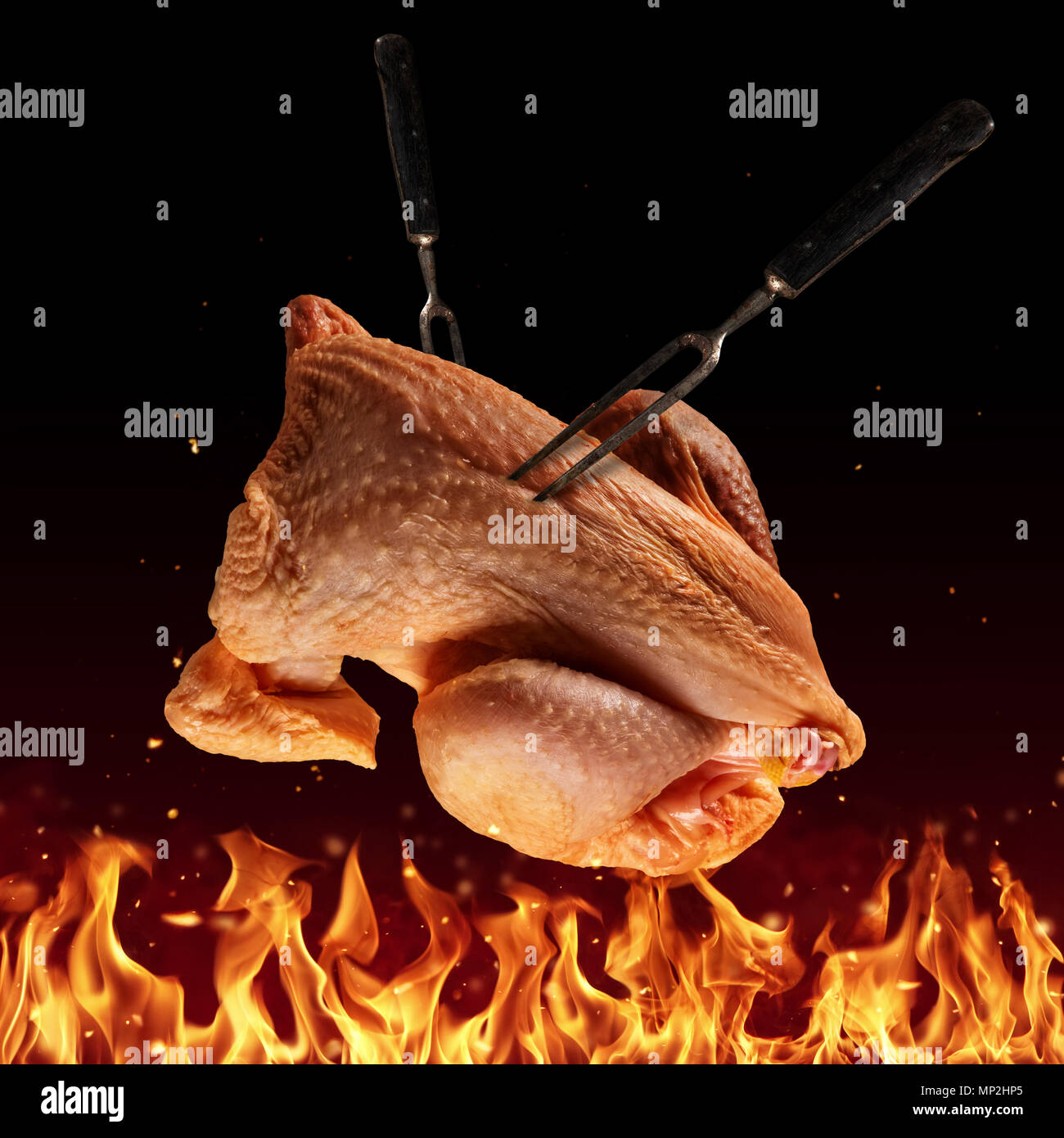Flying whole raw chicken above grill flames, isolated on black ...