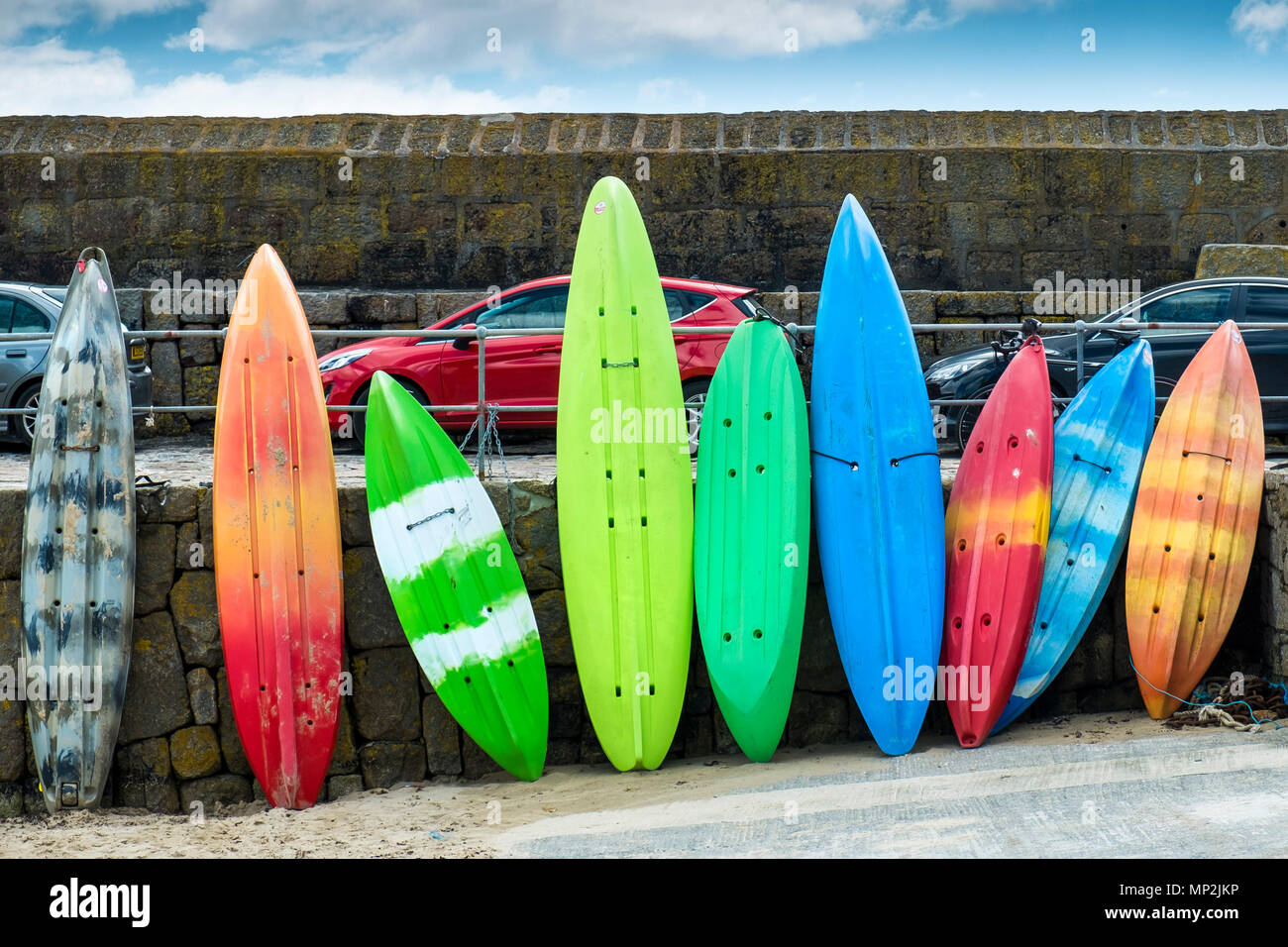 Colourful Kayaks in Mousehole Harbour in Cornwall. Stock Photo