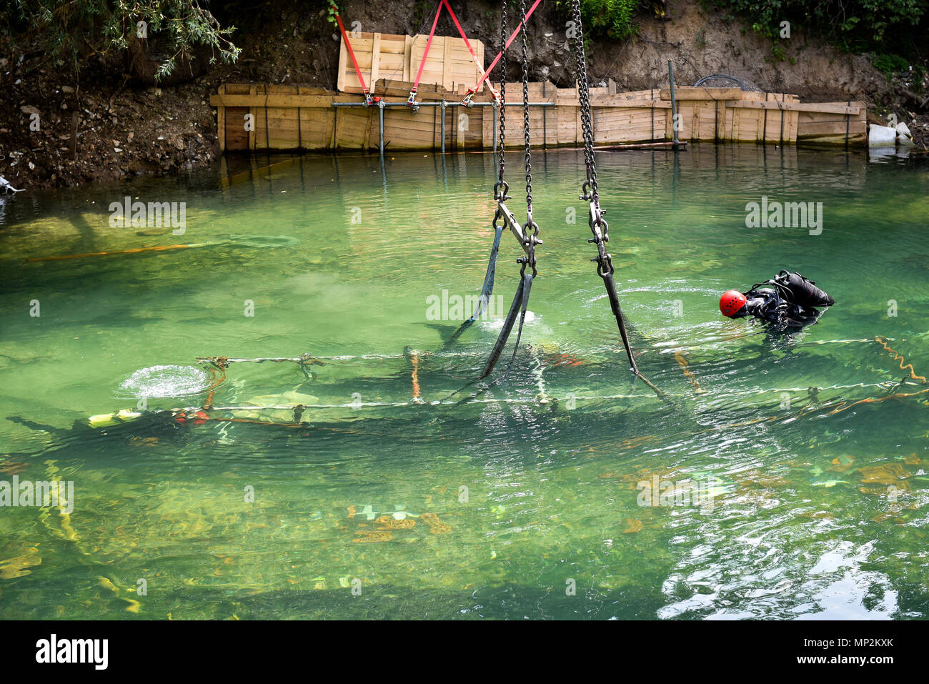 Scuba diver worker is over viewing underwater archaeology works. Lake