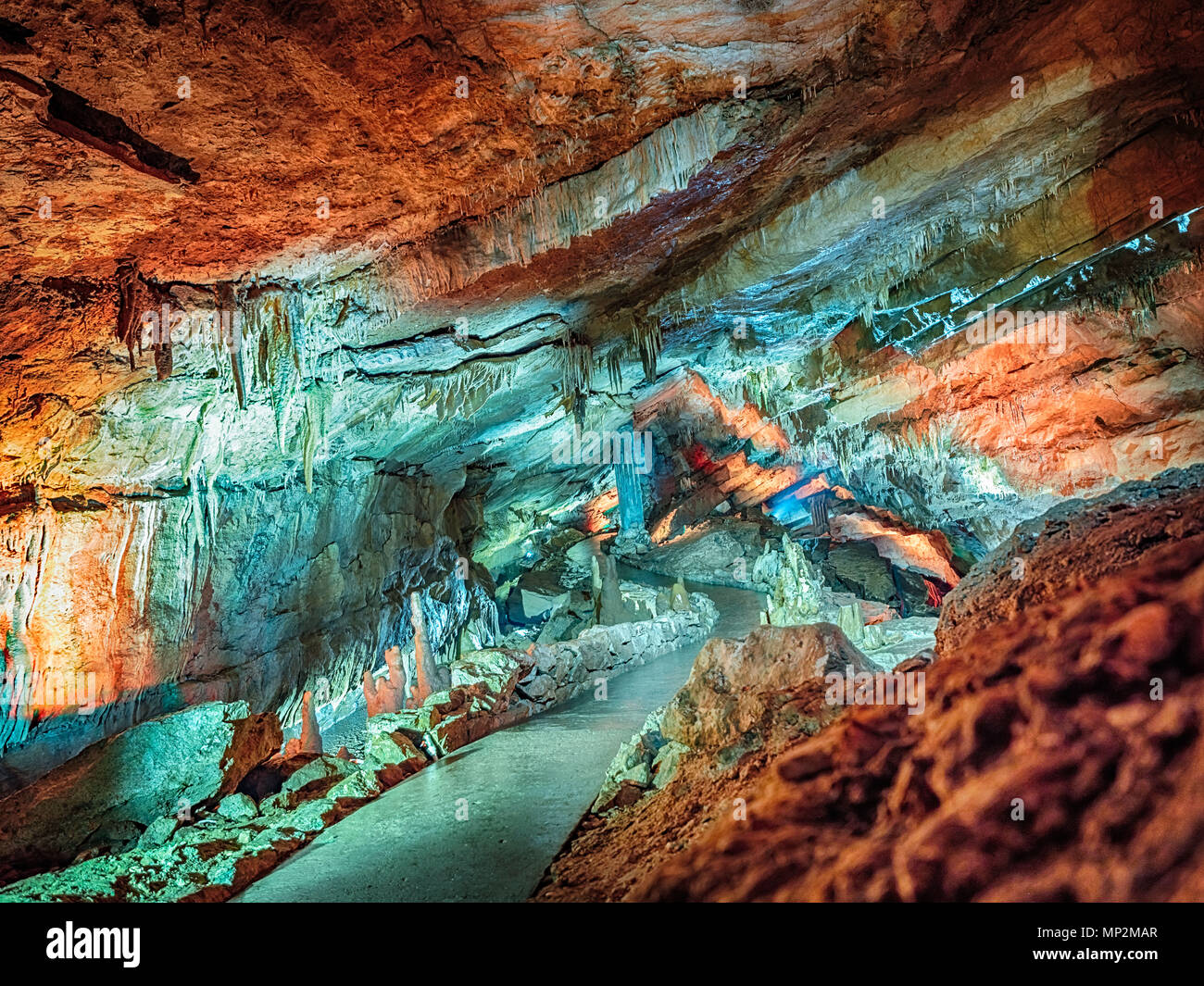 Wonderful Prometheus Cave. Stalactites and stalagmites in the illuminated cave Stock Photo