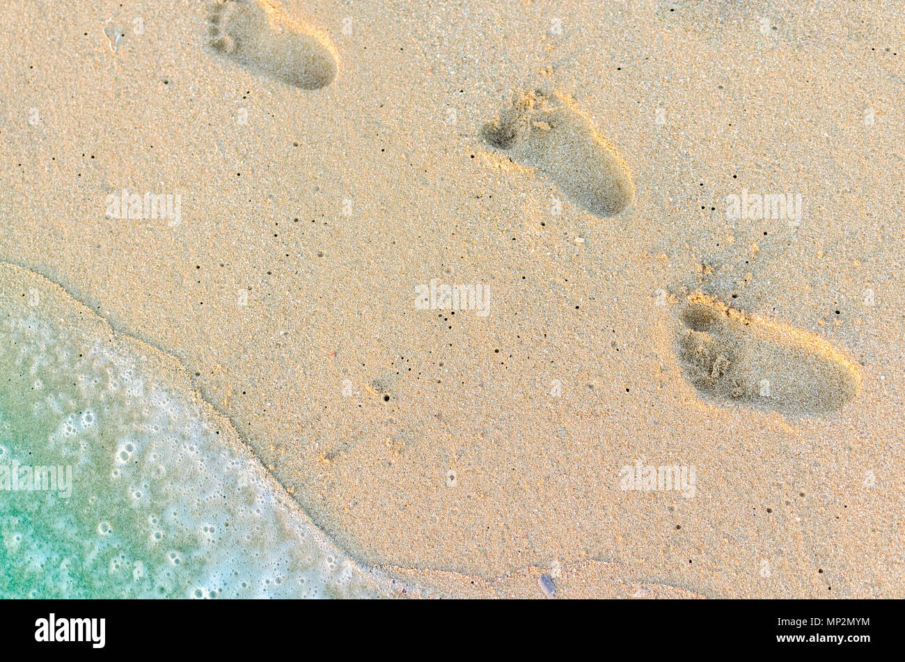 baby footprints in sand