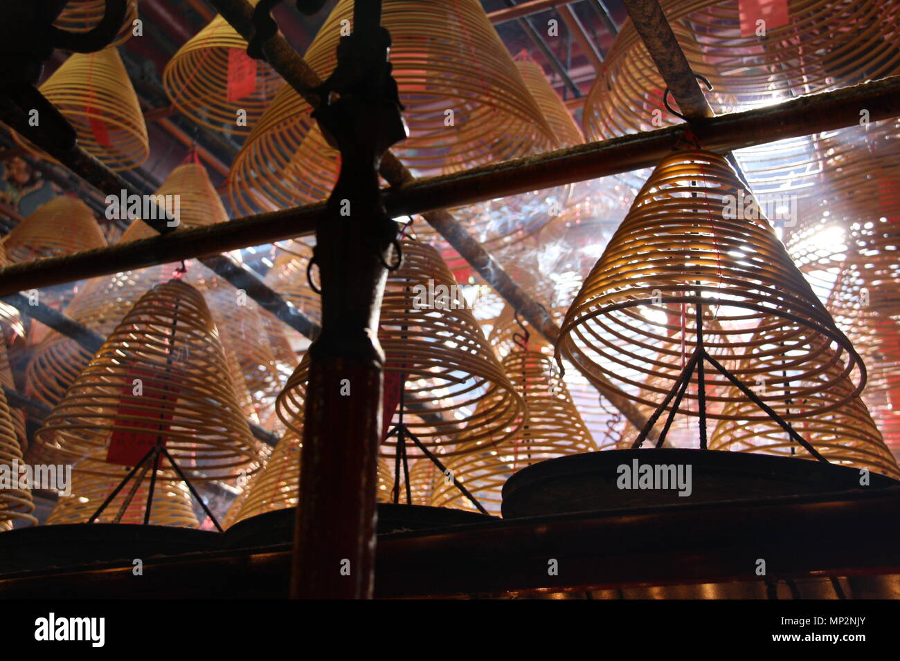 Incense coils smoke overhead at the Man Mo taoist temple in Hong Kong. Stock Photo