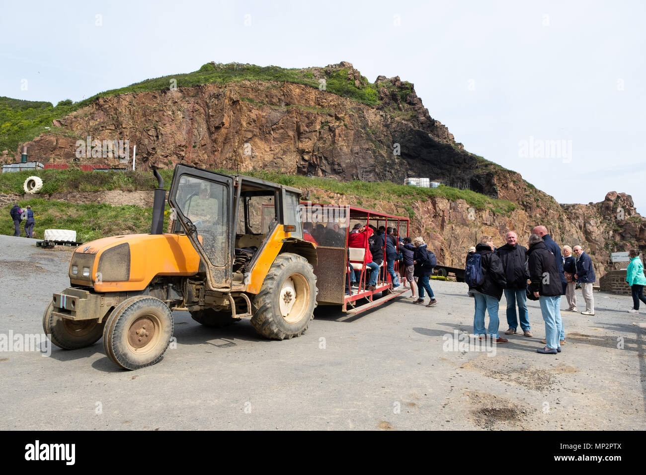 A tractor waiting to transport people from Creux Harbour to the main village on the island of Sark. Stock Photo