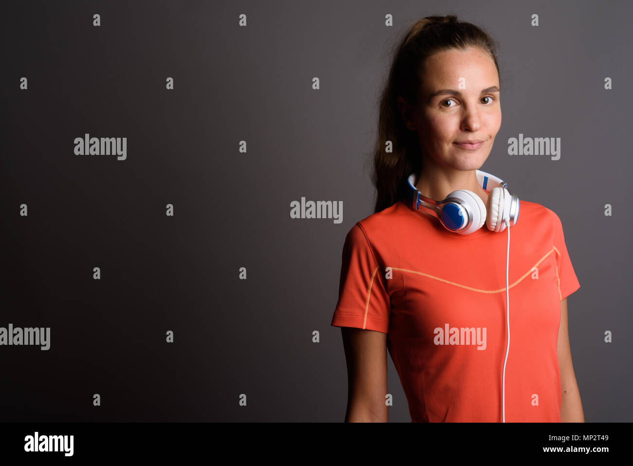 Young beautiful woman with long blond hair wearing headphones ag Stock ...