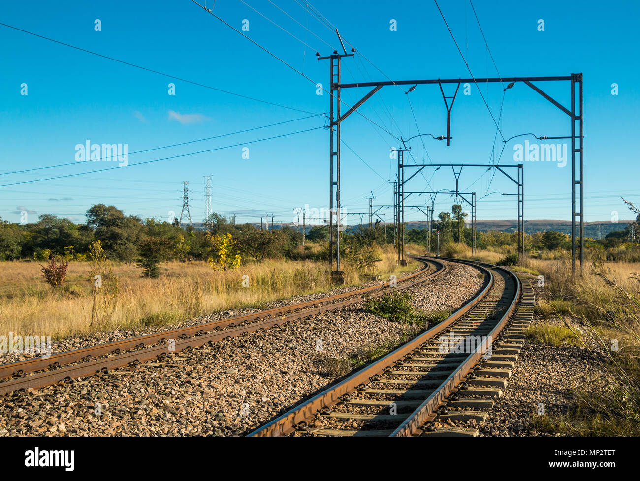 Electric railway lines going through a rural landscape Stock Photo