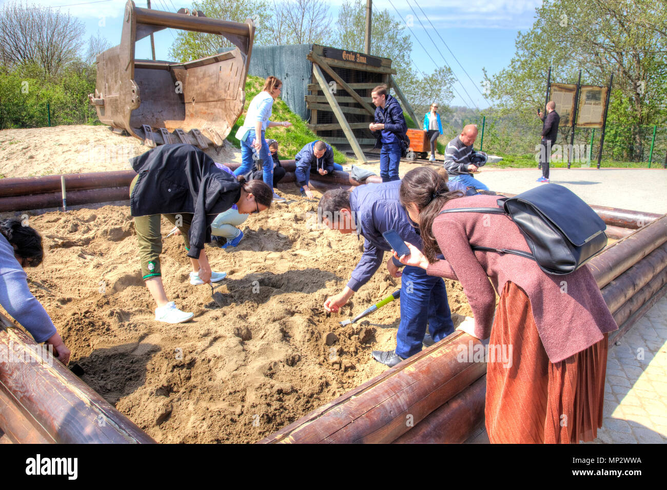 KALININGRAD, RUSSIA - April 29.2018: Tourists are looking for pieces of amber in the sand on the observation deck of the Primorsky quarry. The village Stock Photo