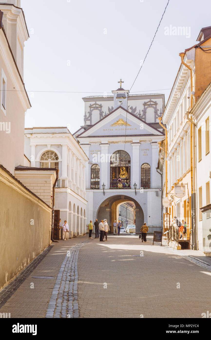 People are walking towards the Gate of Dawn in Vilnius, Lithuania. Stock Photo