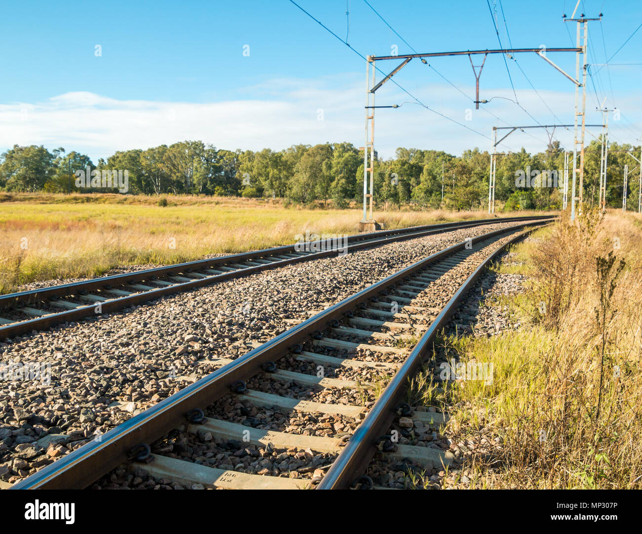 Electric railway lines going through a rural landscape Stock Photo