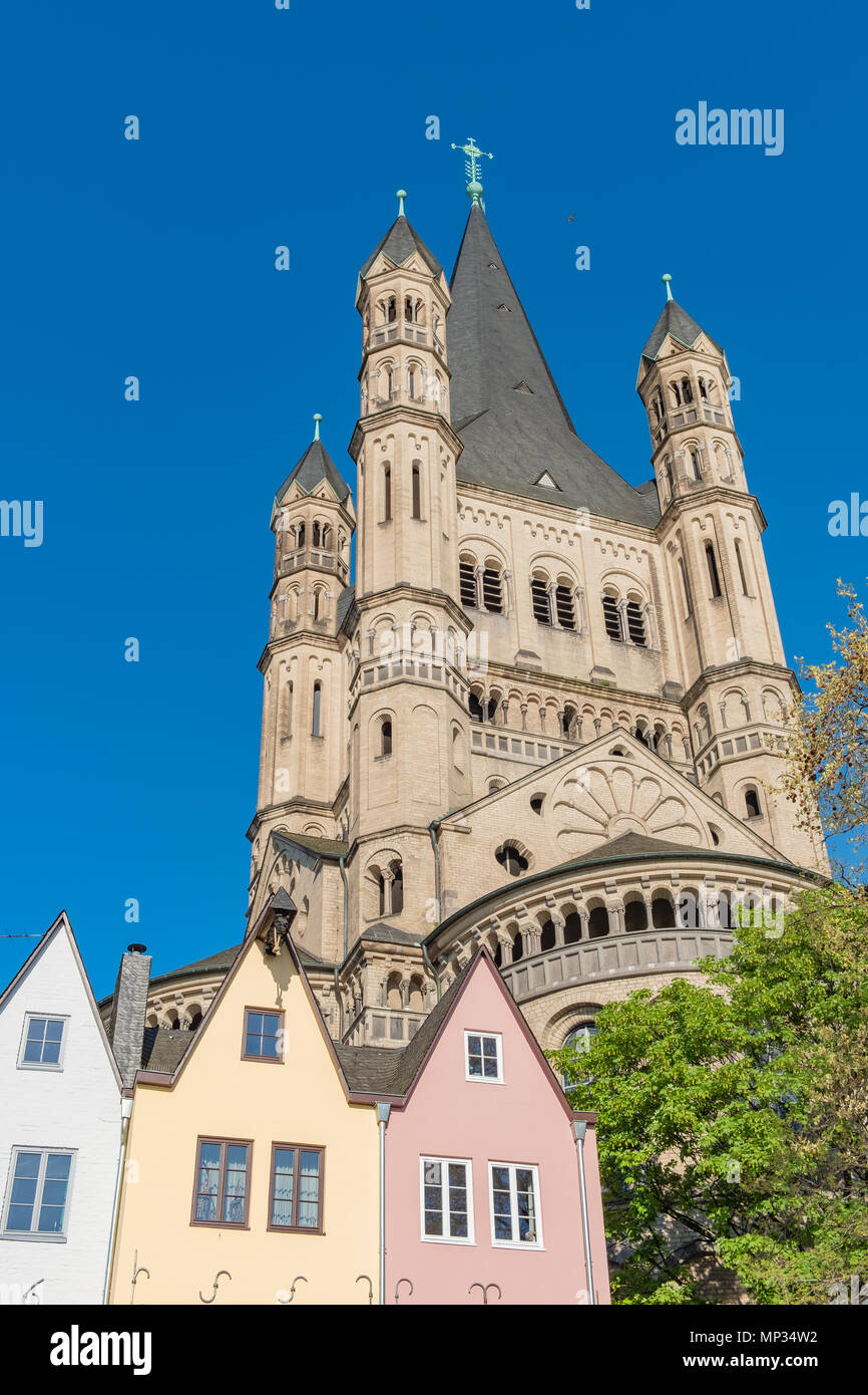 Pretty heritage homes in Cologne Germany with Great St. Martin Church looming in the background. Stock Photo