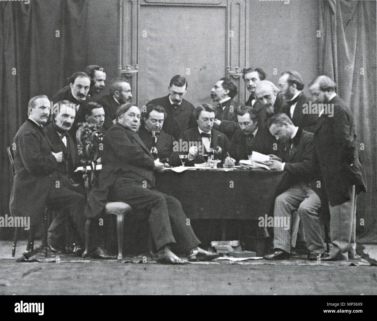 .  English: The editorial board of De Nederlandsche Spectator in 1864. From left to right: T. van Westrheene, J. De Witte van Citters, J.J. Cremer, Jan ten Brink, Arnold Ising, J Bosboom, R.C. Bakhuizen van den Brink, M.F.A.G. Campbell, P.A.S. van Limburg Brouwer, C. Vosmaer, S.L. Verveer, M. Schmidt Crans, J. Cram, S. Van den Berg, L. Mulder, M. Nijhoff and P.J.B.C. Robidé van der Aa; among the signatures: J.Ph. Koelman. Photograph Letterkundig Museum, The Hague . 1864.   921 NederlandscheSpectator Stock Photo