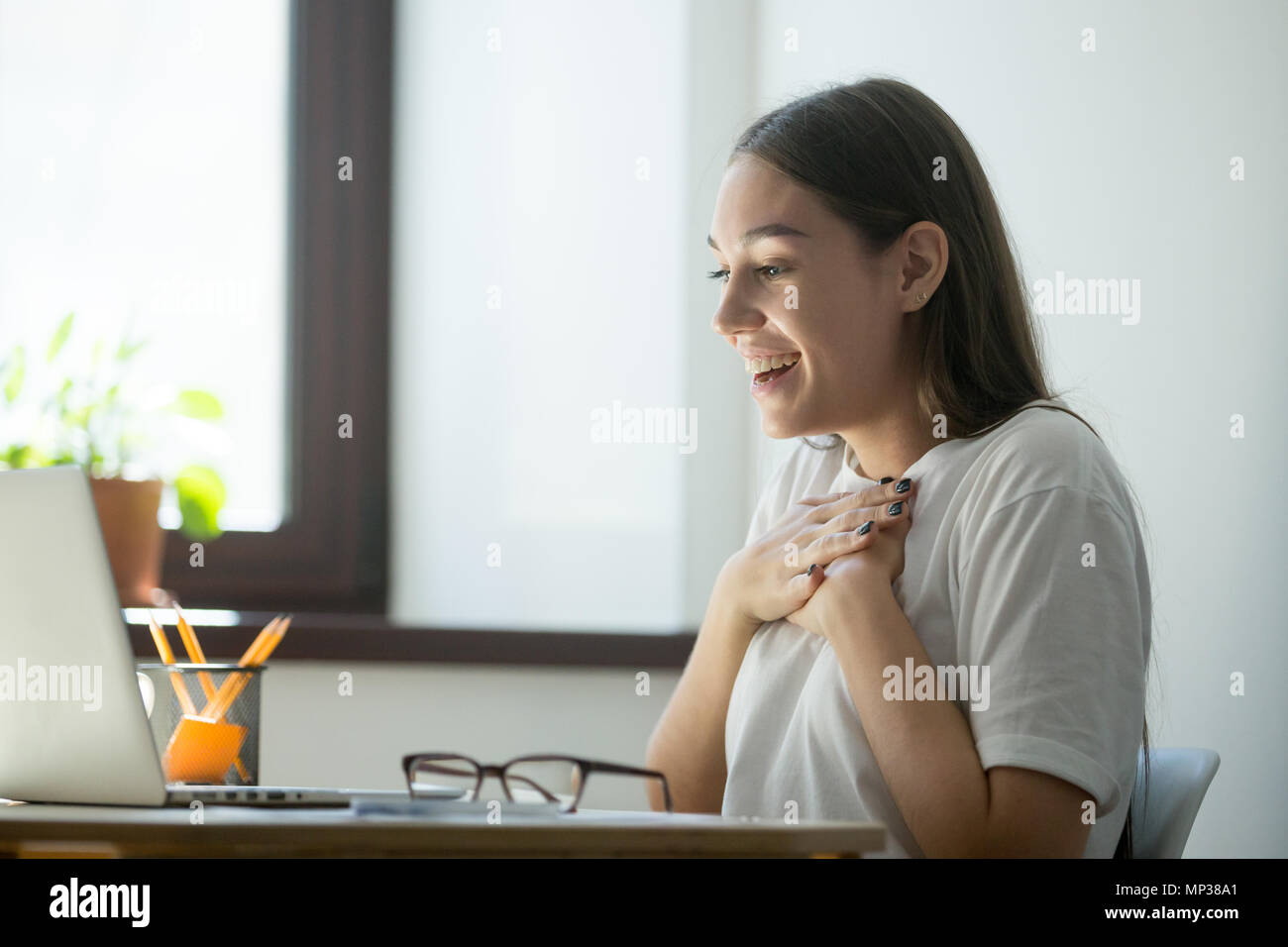 Excited female happy with online win Stock Photo