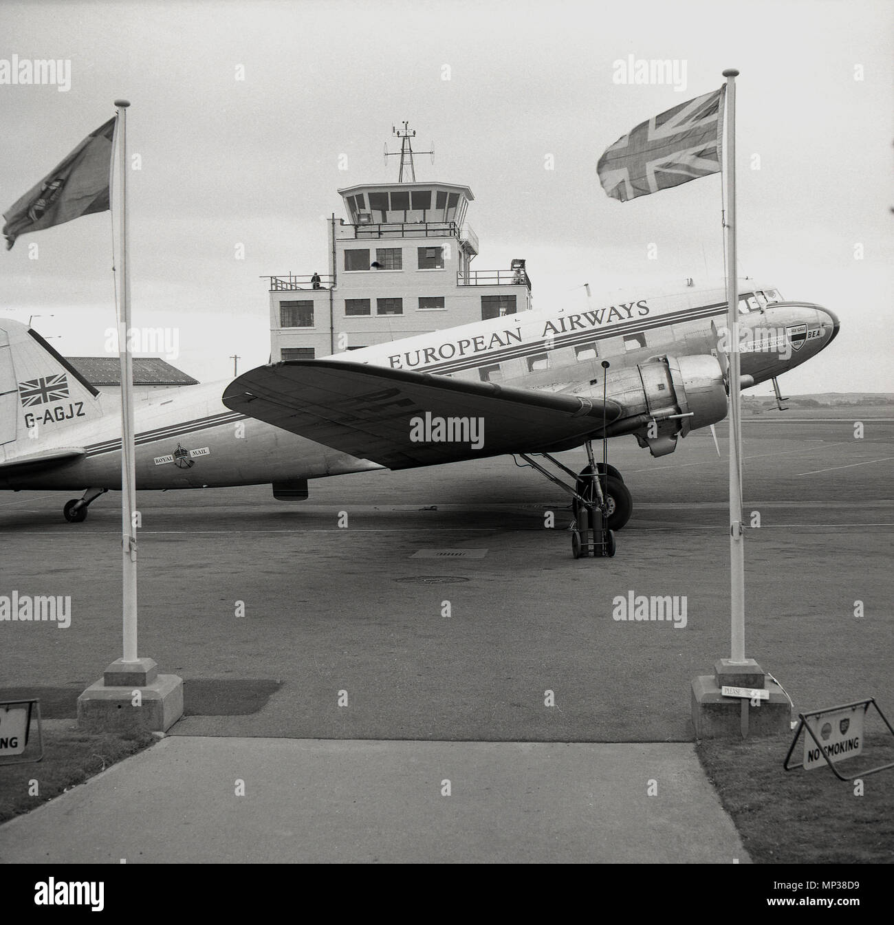 1950s, A Douglas C-47A (DC-3) Skytrain of the airline, Briitsh European Airways parked on a runway outside the entrance to a small european airport, possibly West Berlin in Germany. In the 1960s the Briitsh airline became the fifth biggest passenger-carrying airline in the Western World. The plane shown, built in 1943, was former RAF plane, and was converted by scottish aviation and named RMA John Stringfellow after an early British aviator. It served BEA from 1946 to 1960. Stock Photo