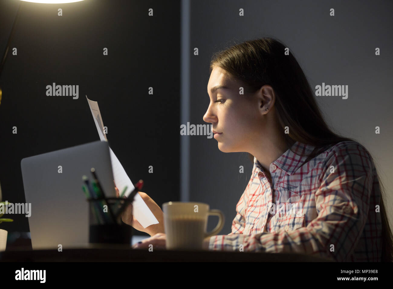 Female worker analyzing company financial reports  Stock Photo