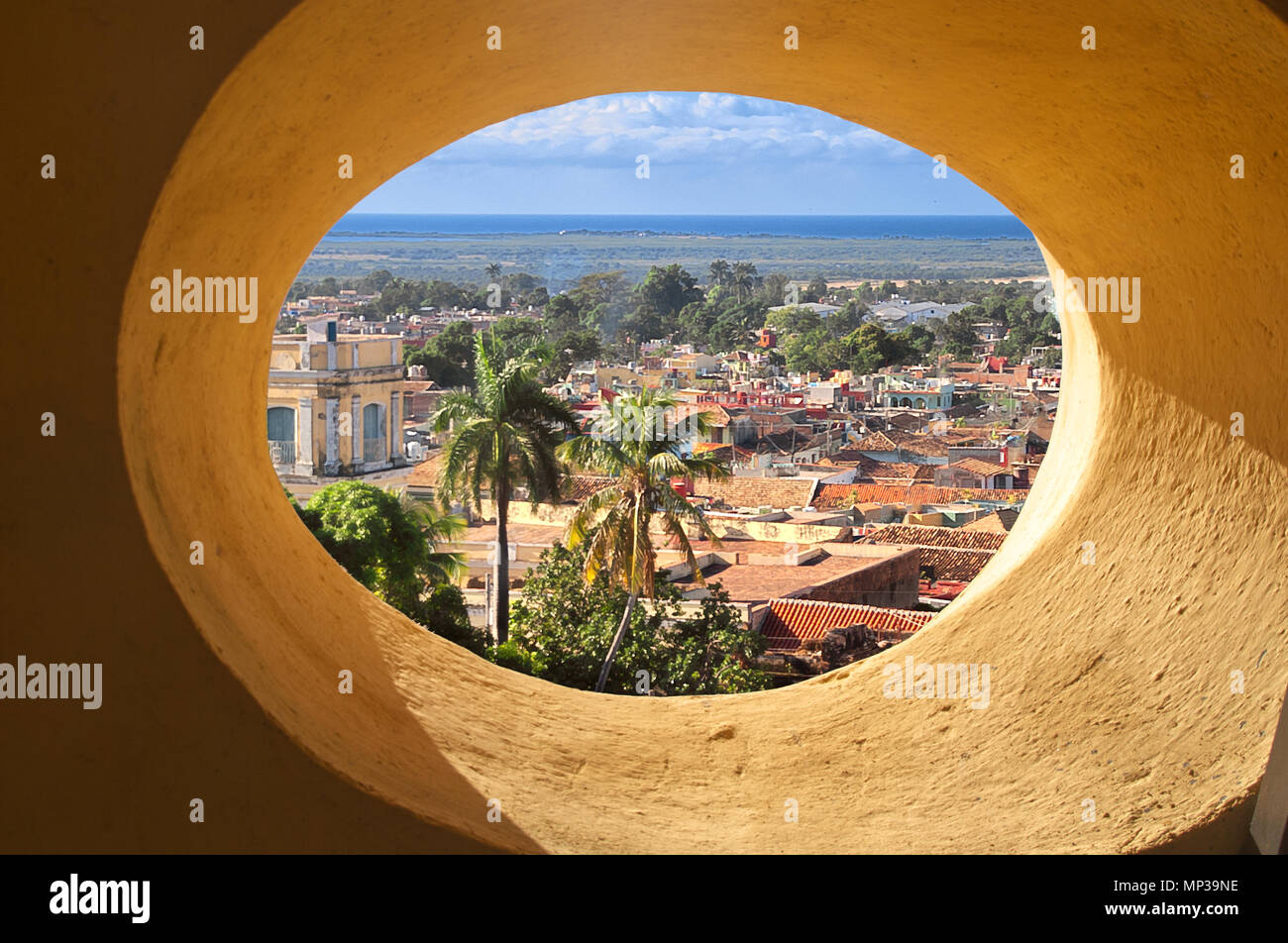 A view of the old city through the round window of the tower. Stock Photo