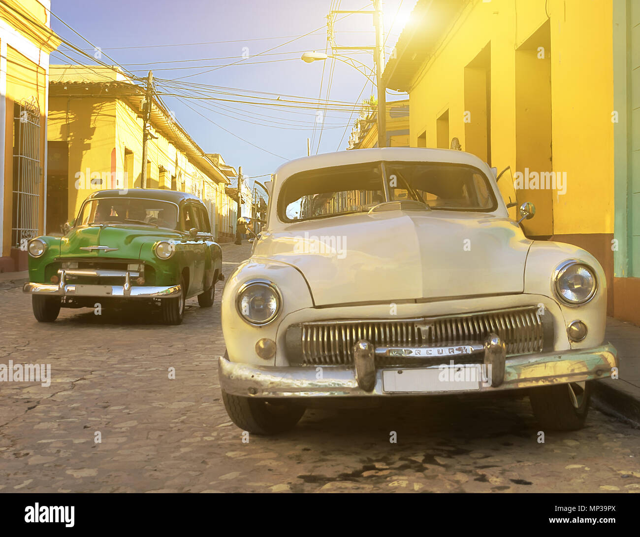 Old, narrow Cuban streets crowded with retro cars Stock Photo