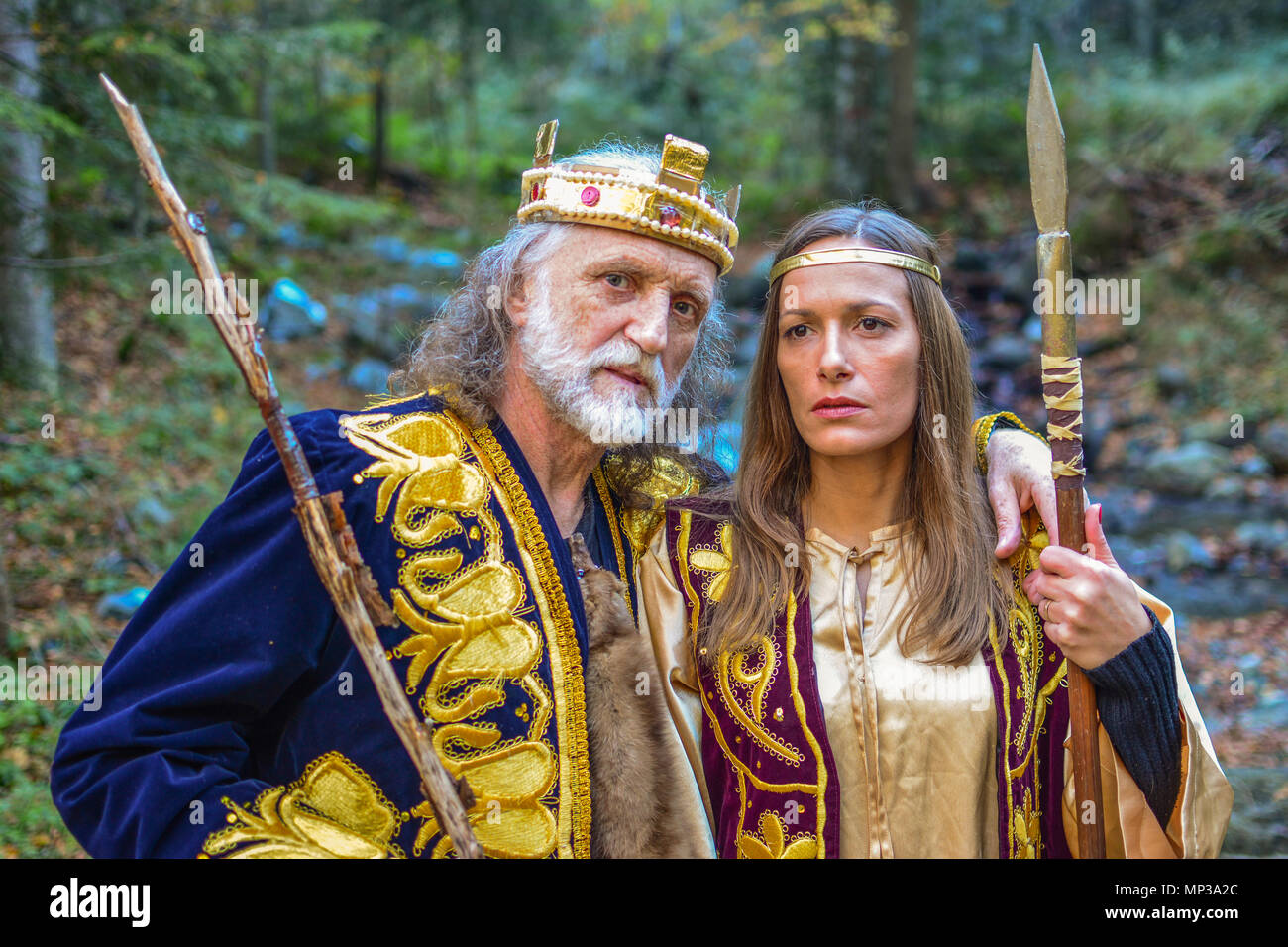 Portrait of king and queen warriors outdoors, in the middle of colorful autumn forest Stock Photo