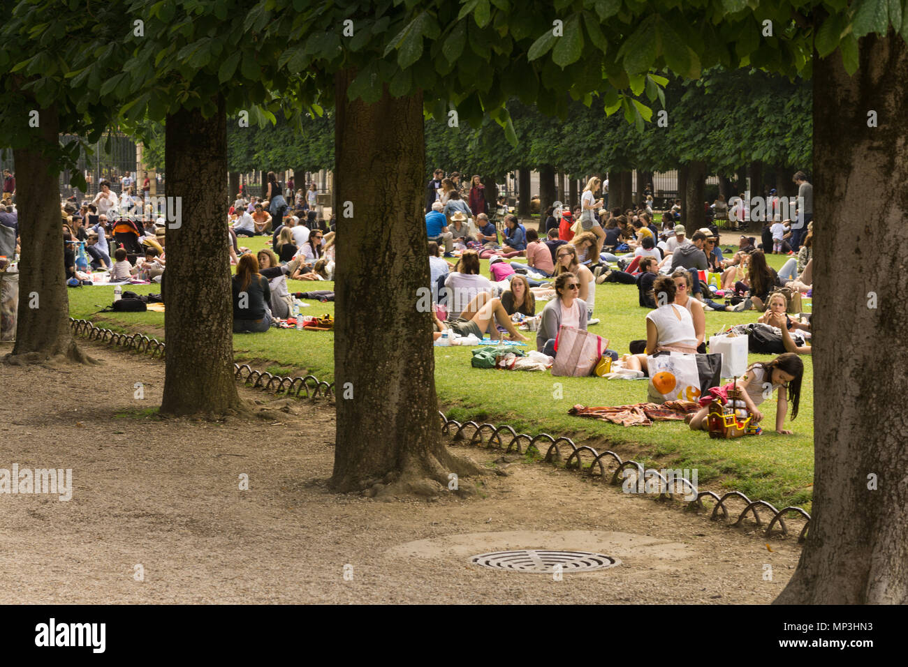 Paris Luxembourg gardens - People relaxing on green lawn at Luxembourg gardens in Paris, France, Europe. Stock Photo