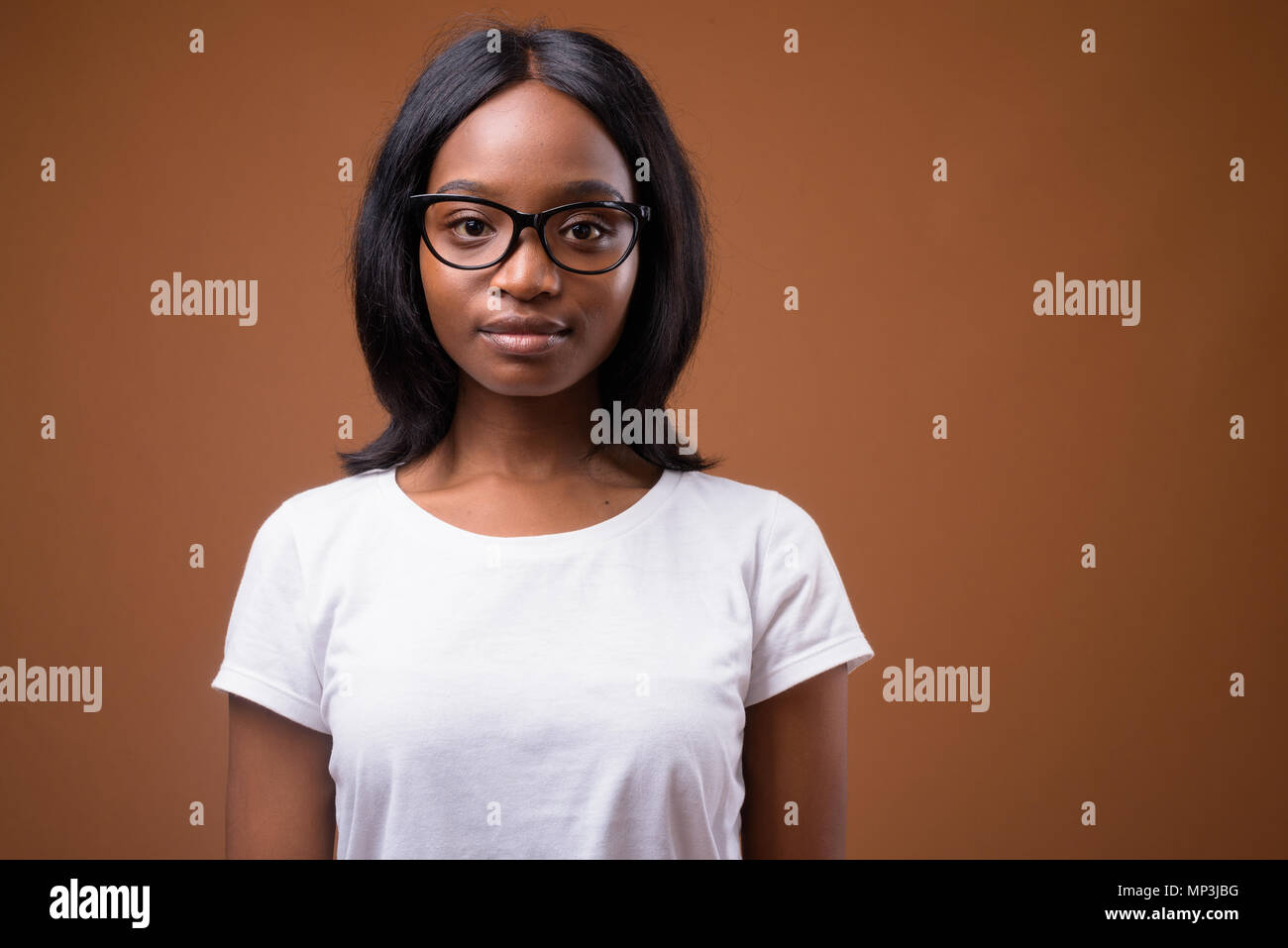 Young beautiful African Zulu woman against brown background Stock Photo