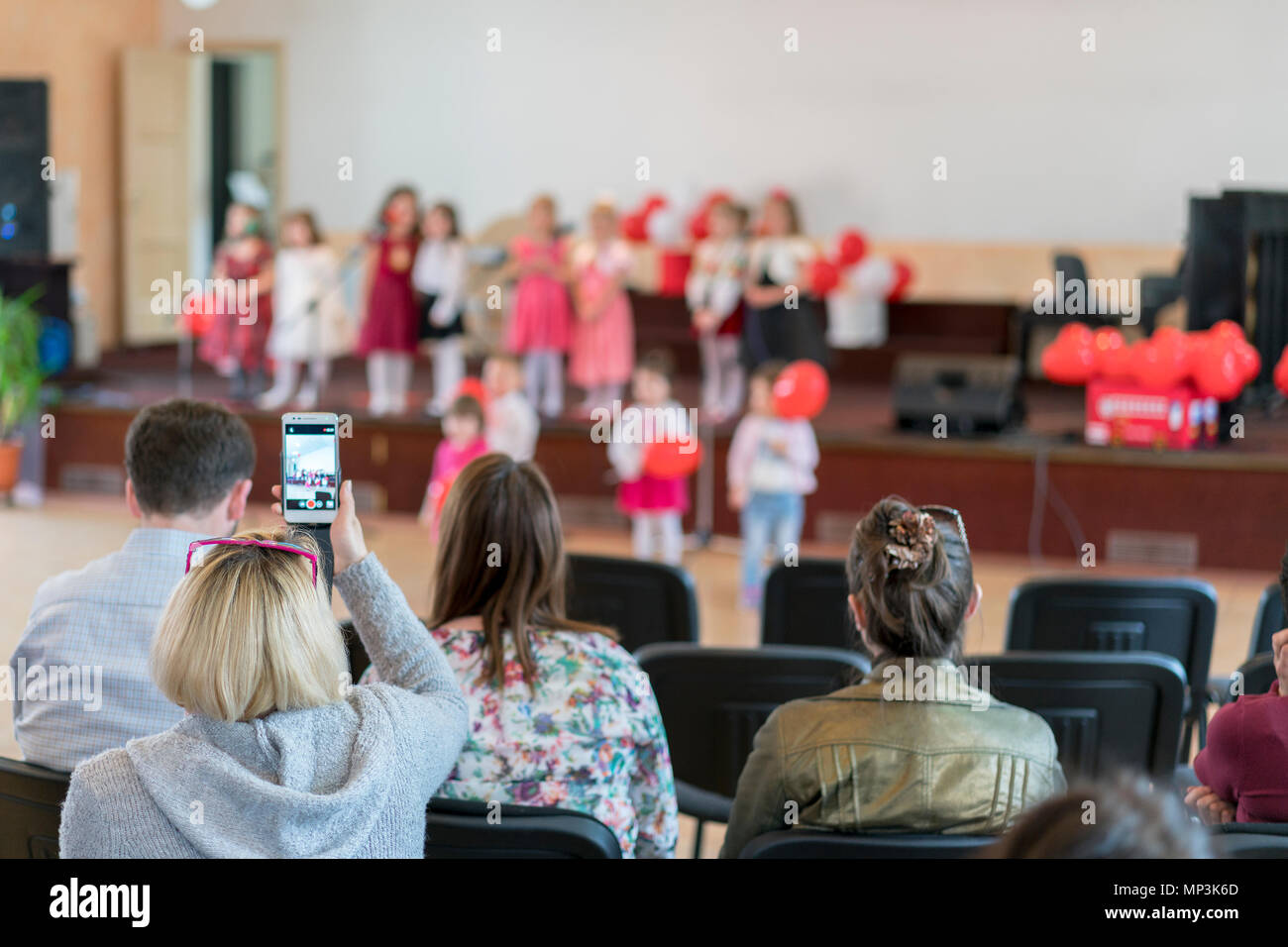 parents are watching the performance children in kindergarten. A ...