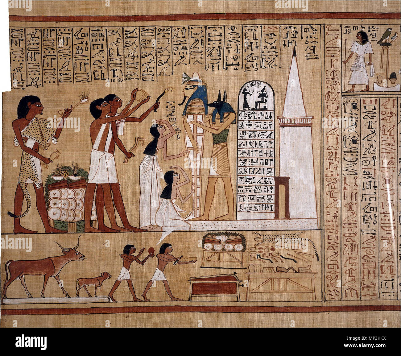 .  'This is an excellent example of one of the many fine vignettes (illustrations) from the Book of the Dead of Hunefer. The centrepiece of the upper scene is the mummy of Hunefer, shown supported by the god Anubis (or a priest wearing a jackal mask). Hunefer's wife and daughter mourn, and three priests perform rituals. The two priests with white sashes are carrying out the Opening of the Mouth ritual. The white building at the right is a representation of the tomb, complete with portal doorway and small pyramid. Both these features can be seen in real tombs of this date from Thebes. To the le Stock Photo