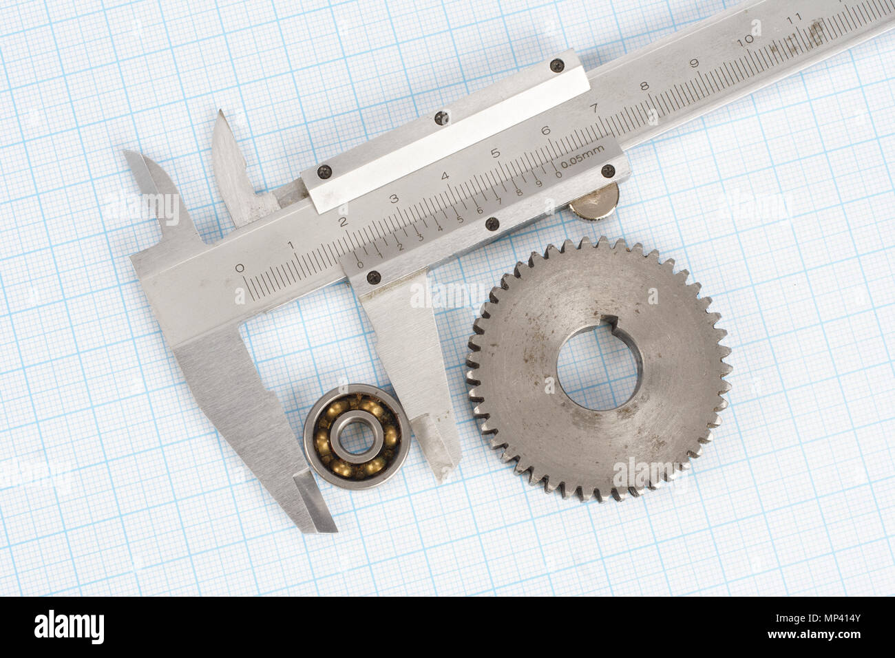 gear, bearing and caliper on graph paper background Stock Photo Alamy