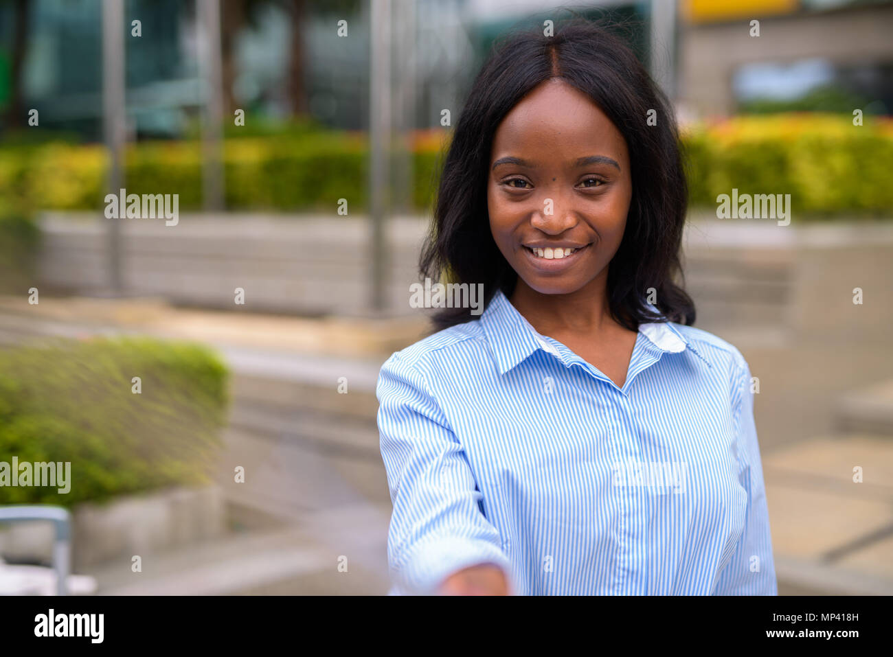 Young beautiful African Zulu businesswoman relaxing outside the  Stock Photo