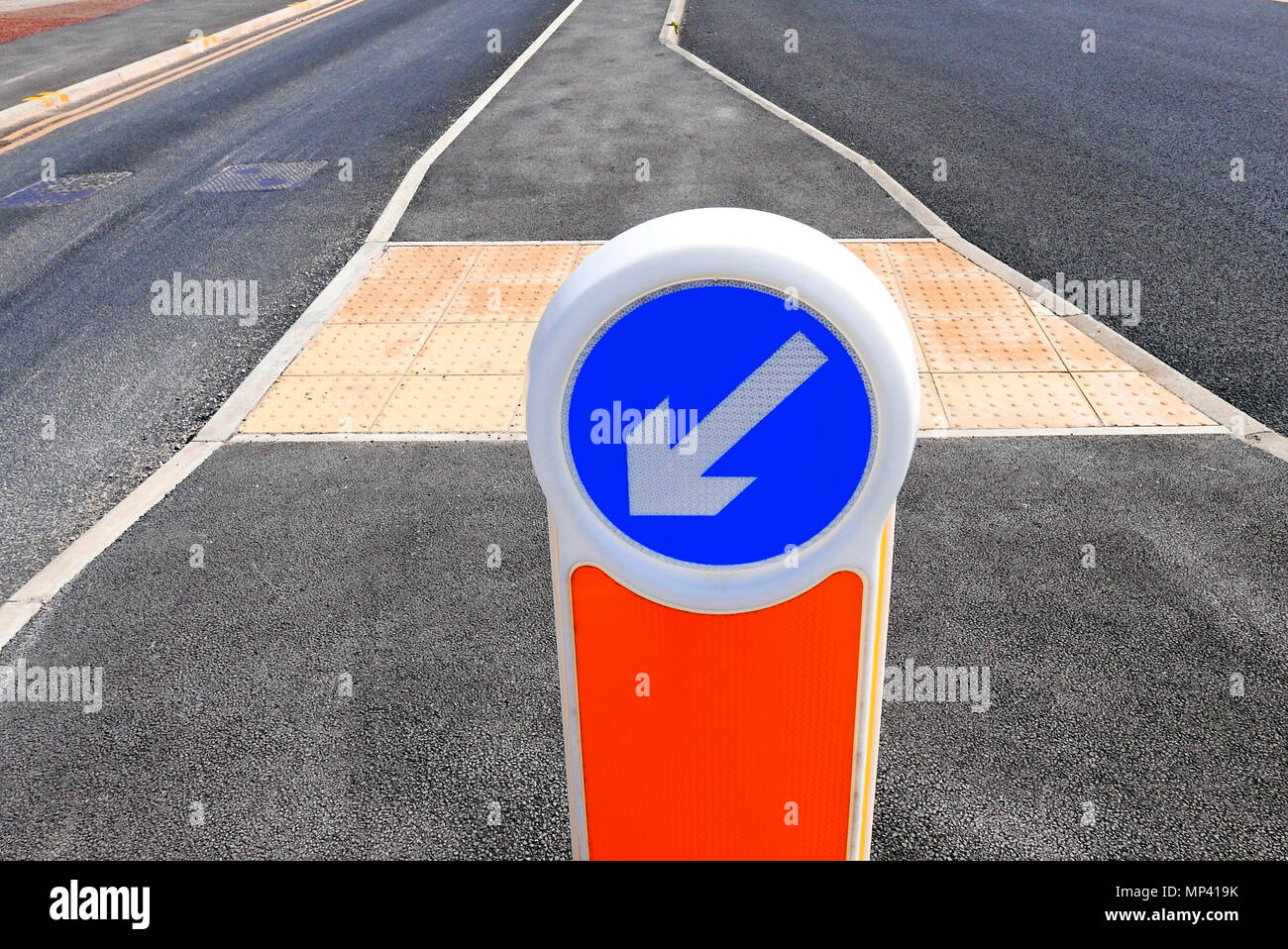 Keep left bollard on traffic island in middle of road Stock Photo