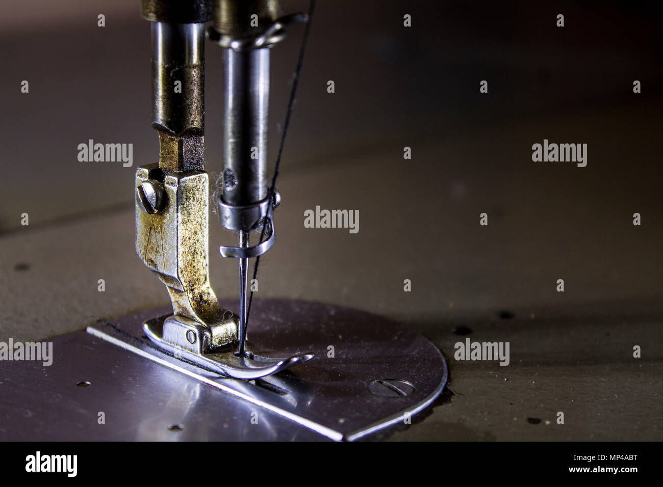 Classic retro style metallic sewing machine ready for sewing, needle