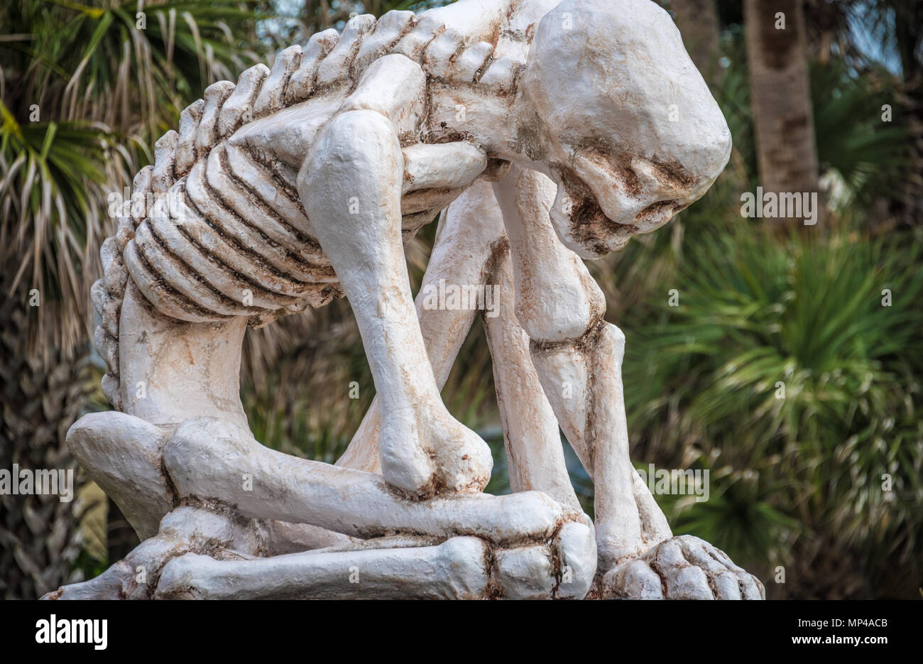 Crouching Skeletal Figure sculpture by Matt Stanford on display at UNFs Seaside Sculpture Park in Jacksonville Beach, Florida. (USA) Stock Photo